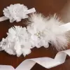 White sash with flowers and feathers 