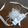 Bracelet with white satin bow, pearl centre and feathers