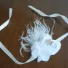 Bracelet with white flowers, feathers and crystal centre
