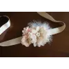Flower and feather sash with champagne and peach flowers