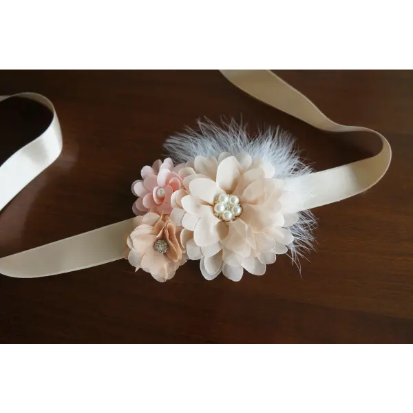 Flower and feather sash with champagne and peach flowers
